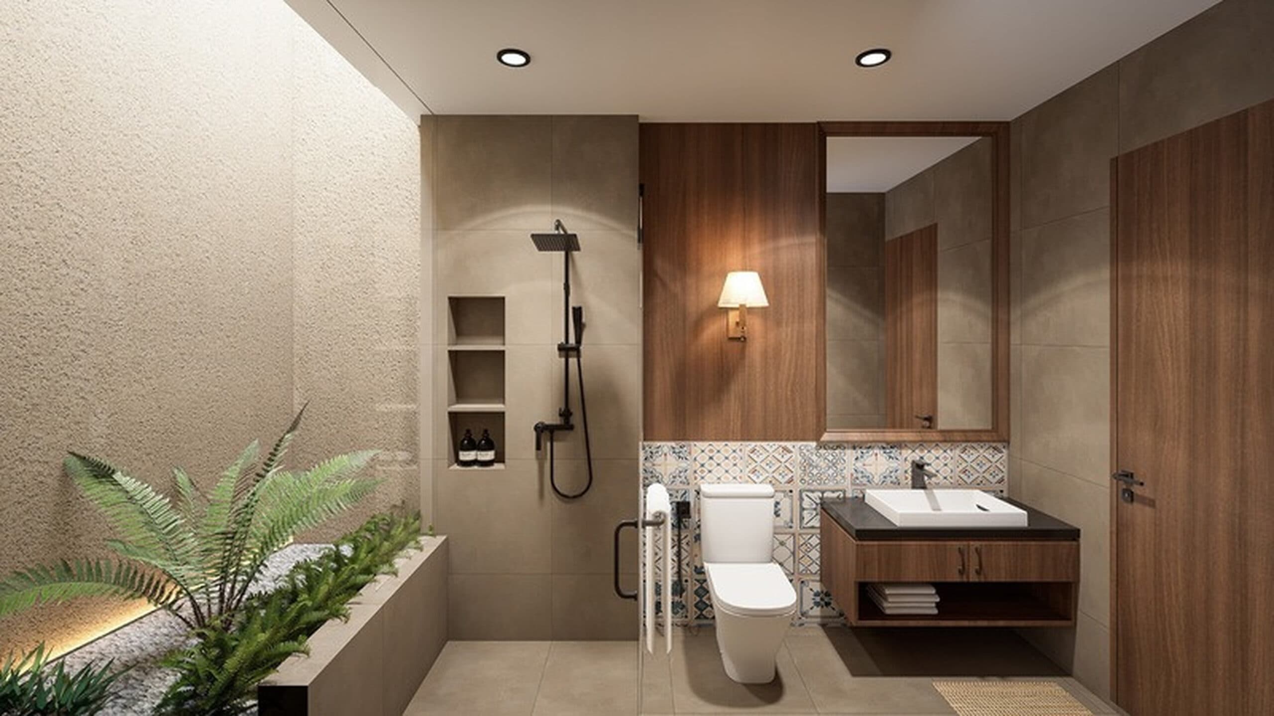 Bathroom interior featuring warm wooden paneling, a wall-mounted light fixture, recessed shower shelves, and lush greenery in a gravel planter