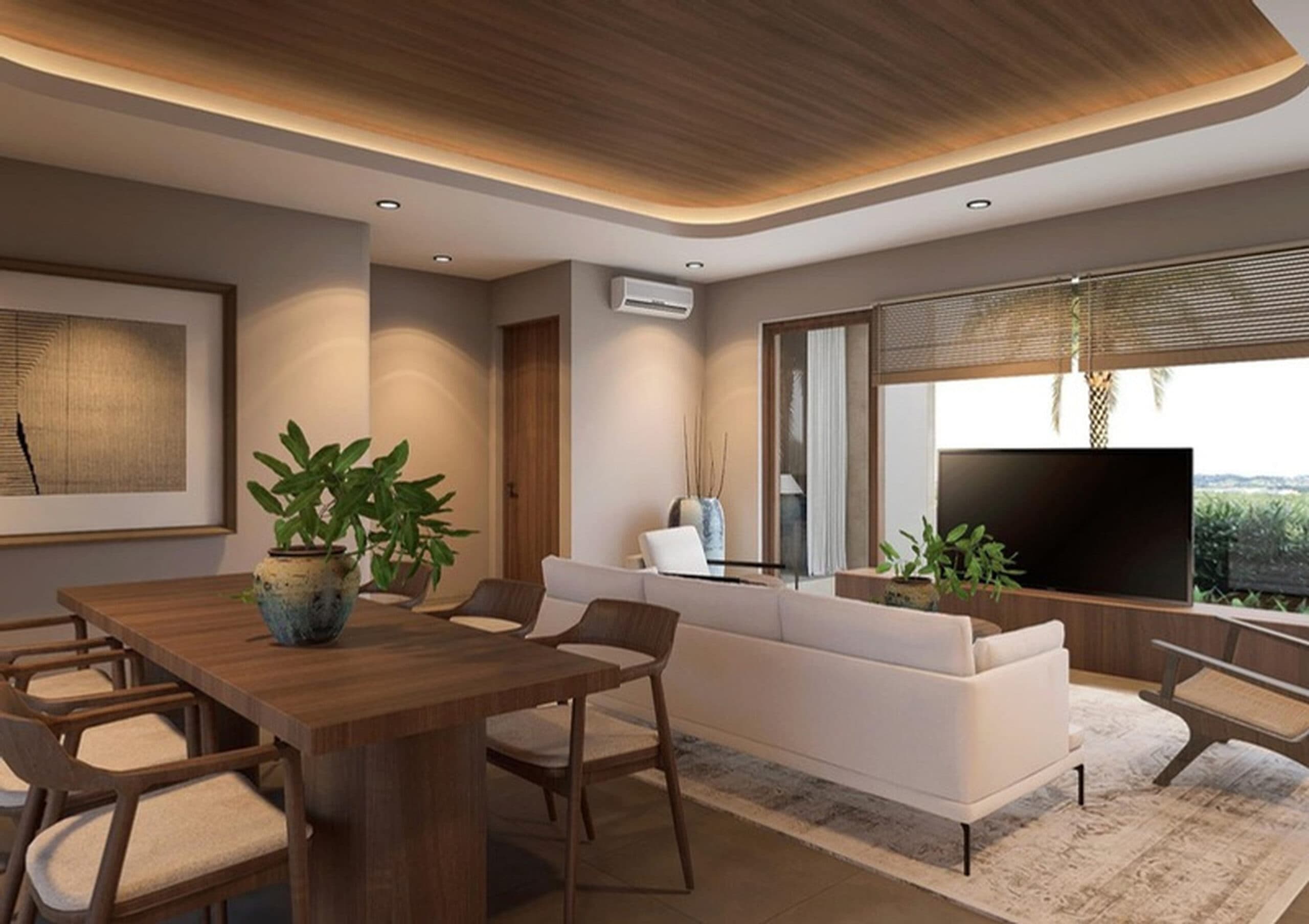 Open-plan dining and living area with a dark wood dining table, white sofa, woven accent chairs, and a tray ceiling with warm LED lighting.