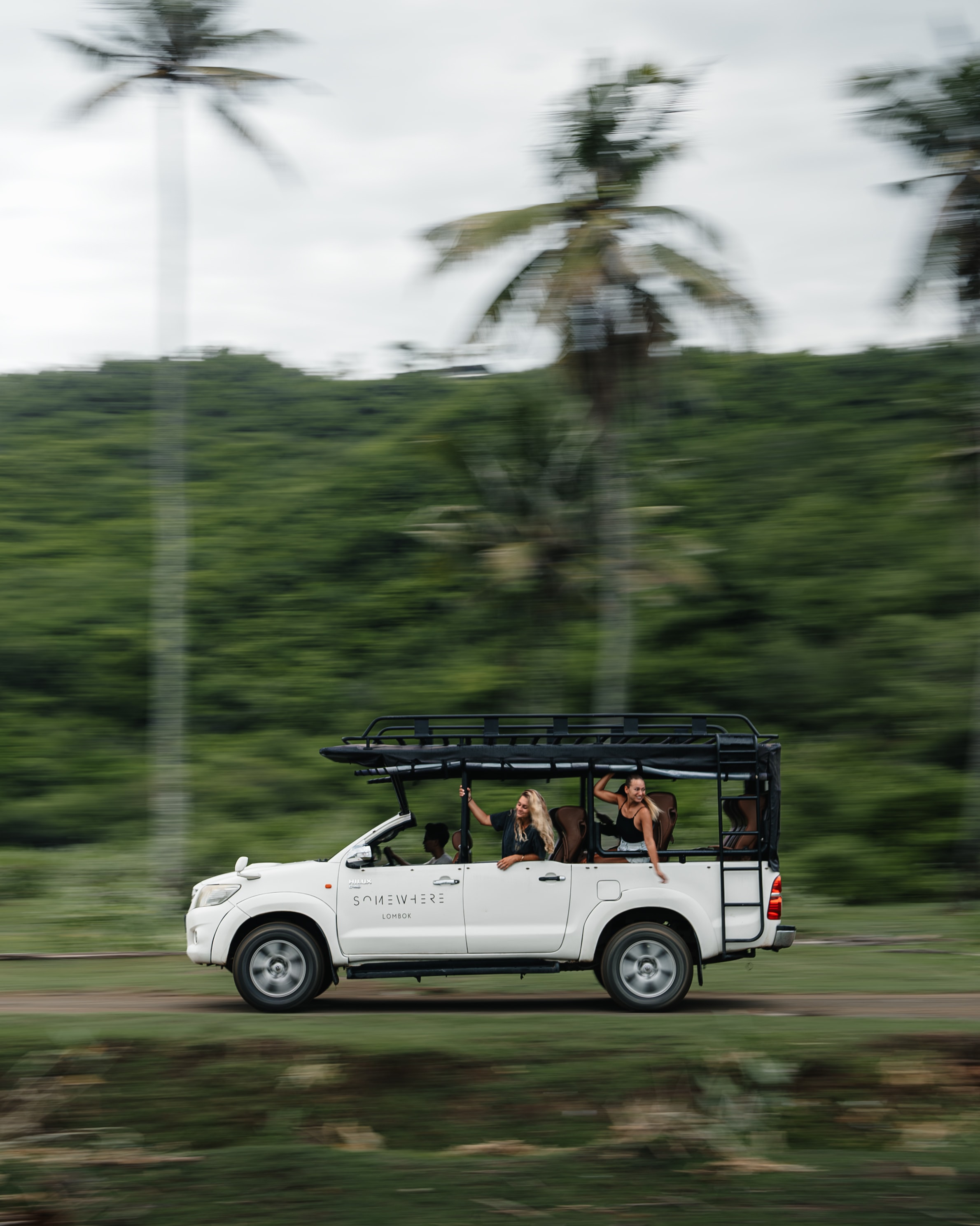 Safari-style vehicle with passengers.