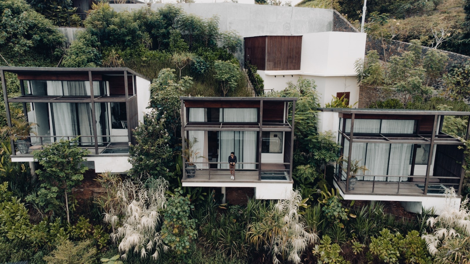 Adjoining modern hillside villas with private balconies.