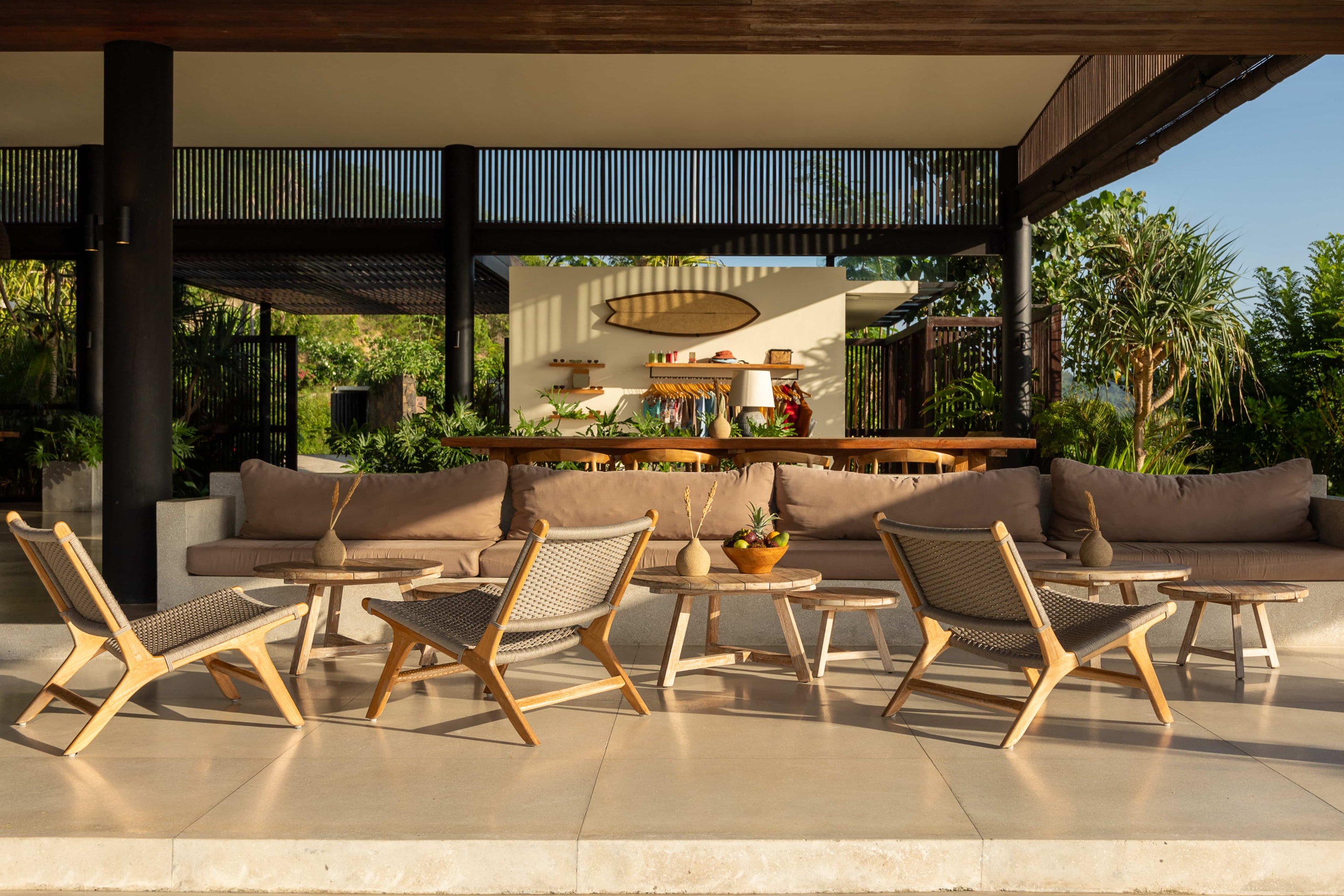 Open-air resort lounge and bar area with curated furniture.