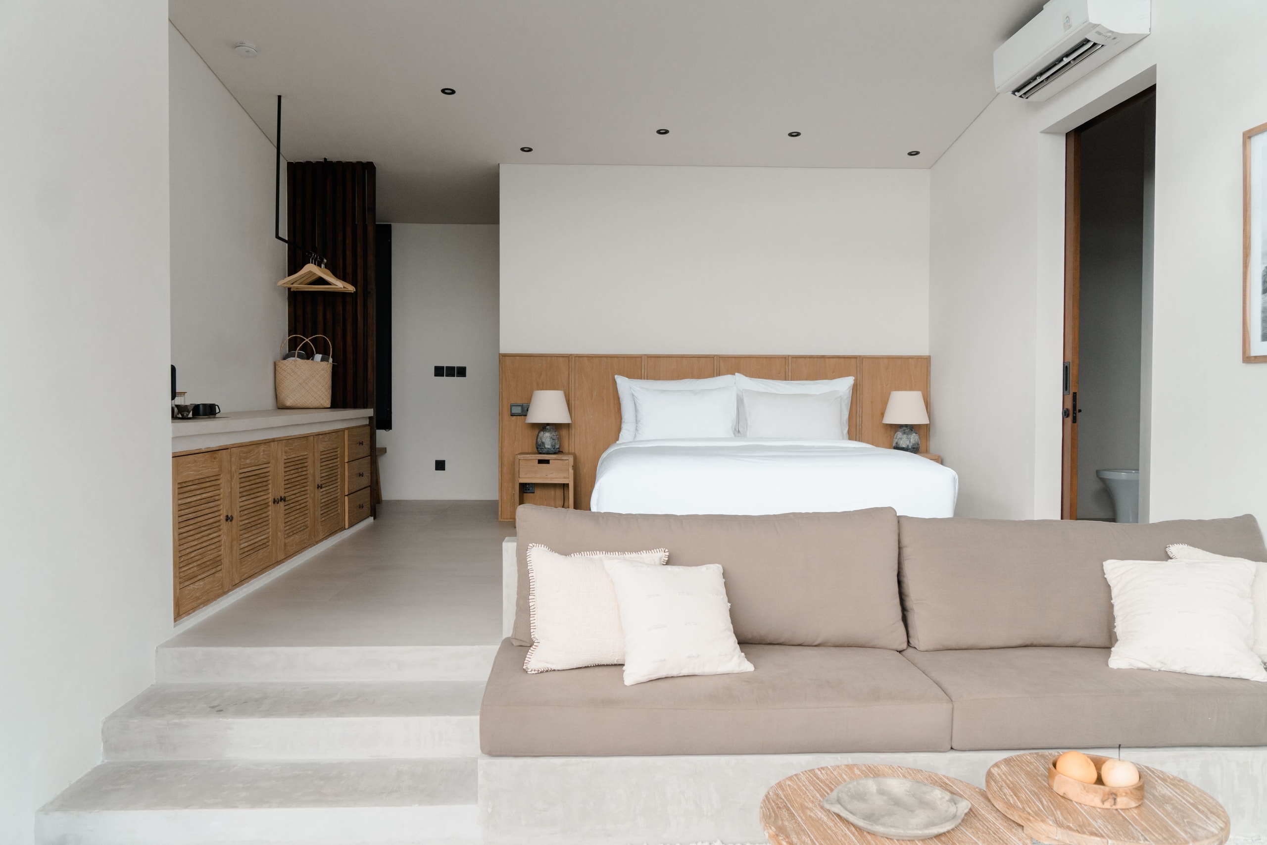 Interior view of a resort bedroom showing steps and a lounge.
