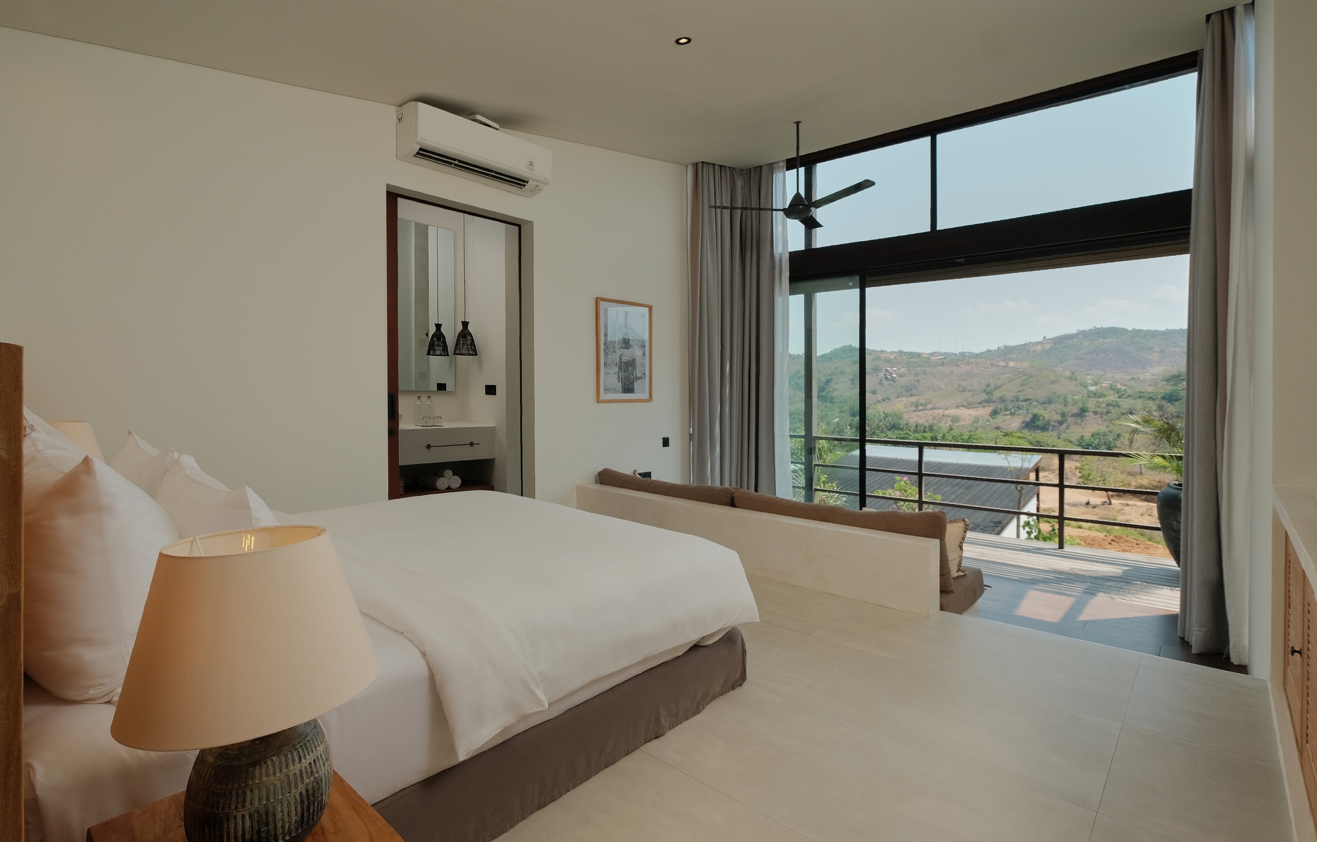 Modern resort bedroom with scenic balcony views.