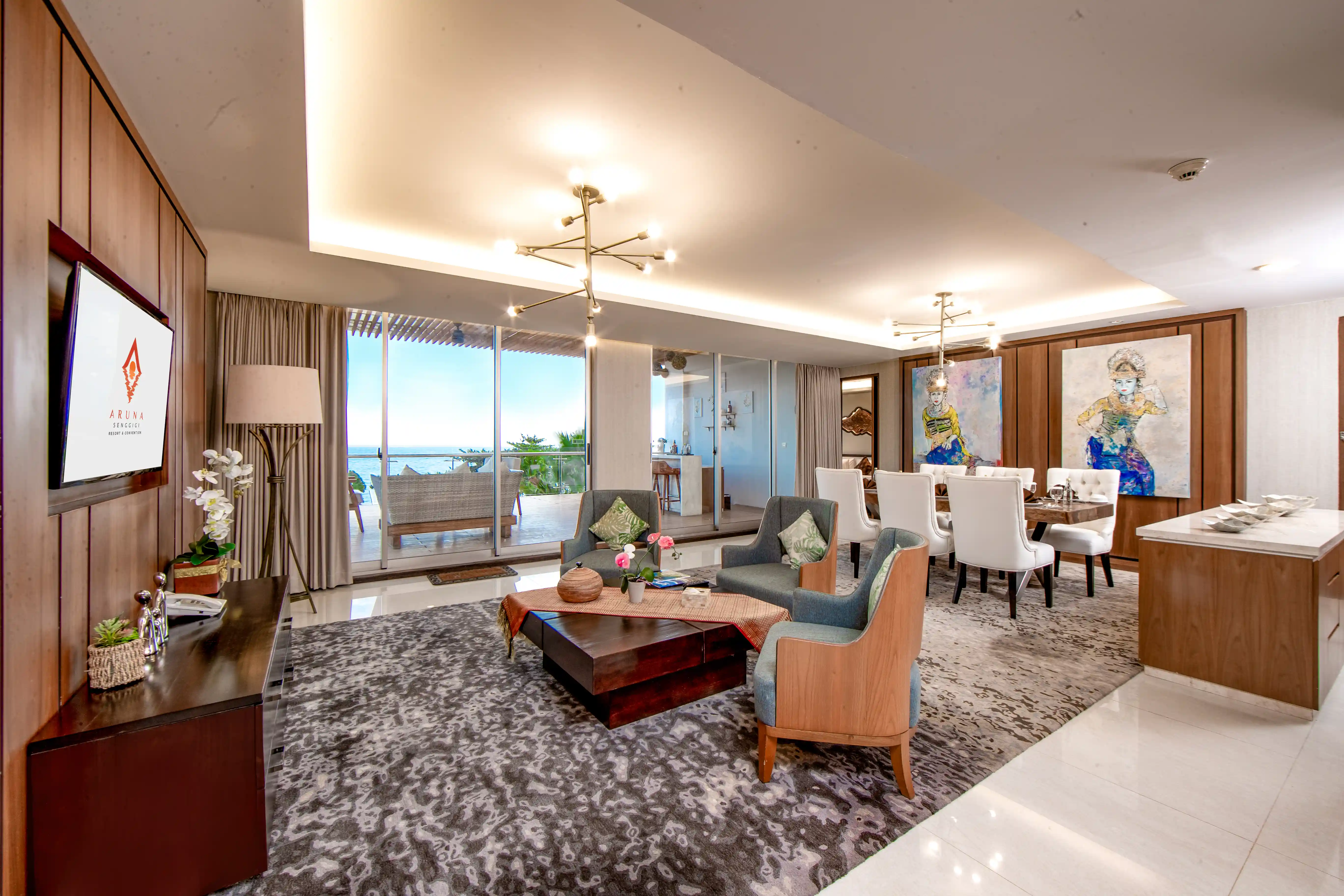 Modern luxury suite featuring a spacious living room, large dining table, and a balcony with a ocean view.