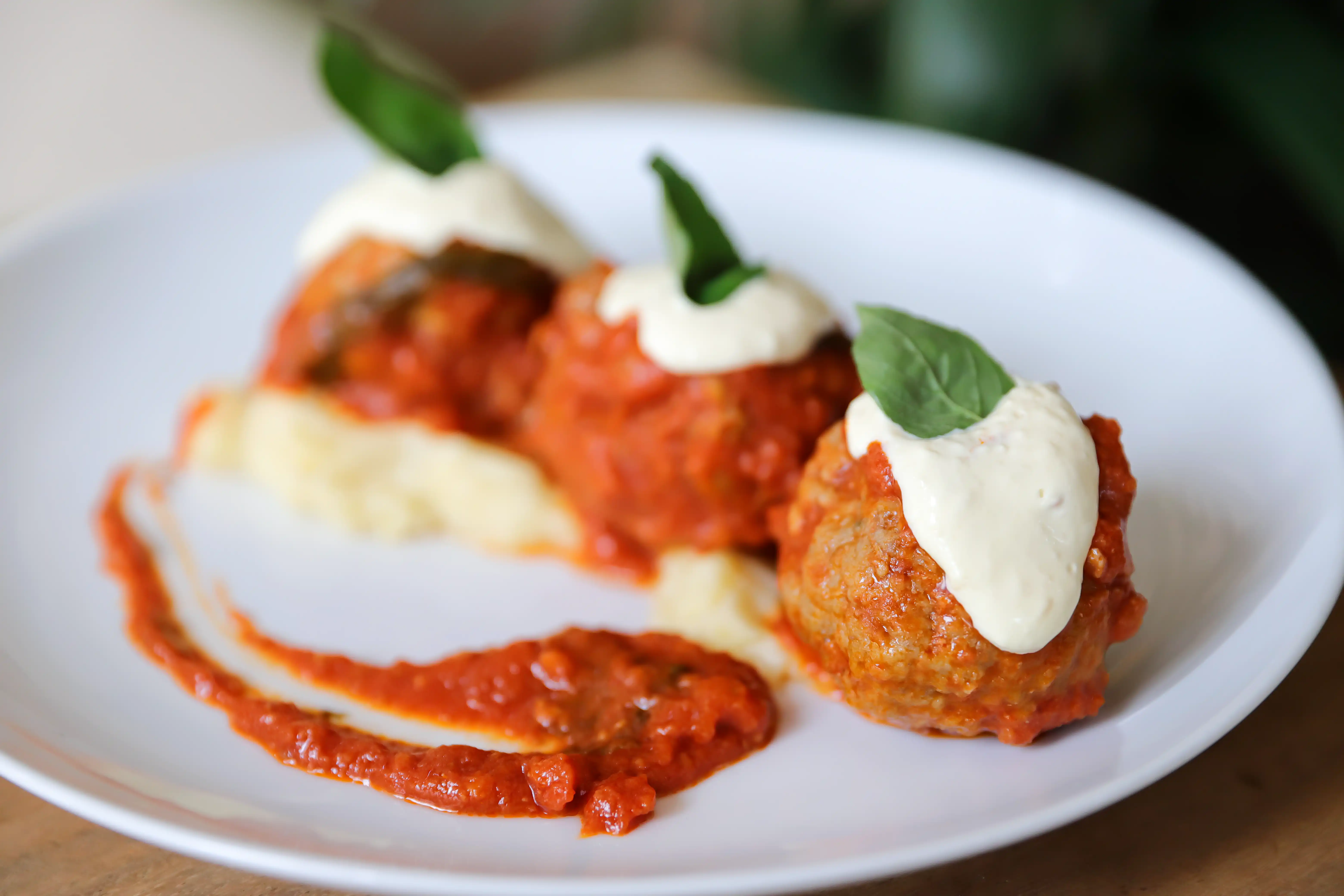 Italian meatballs served with tomato sauce, cream and fresh basil.
