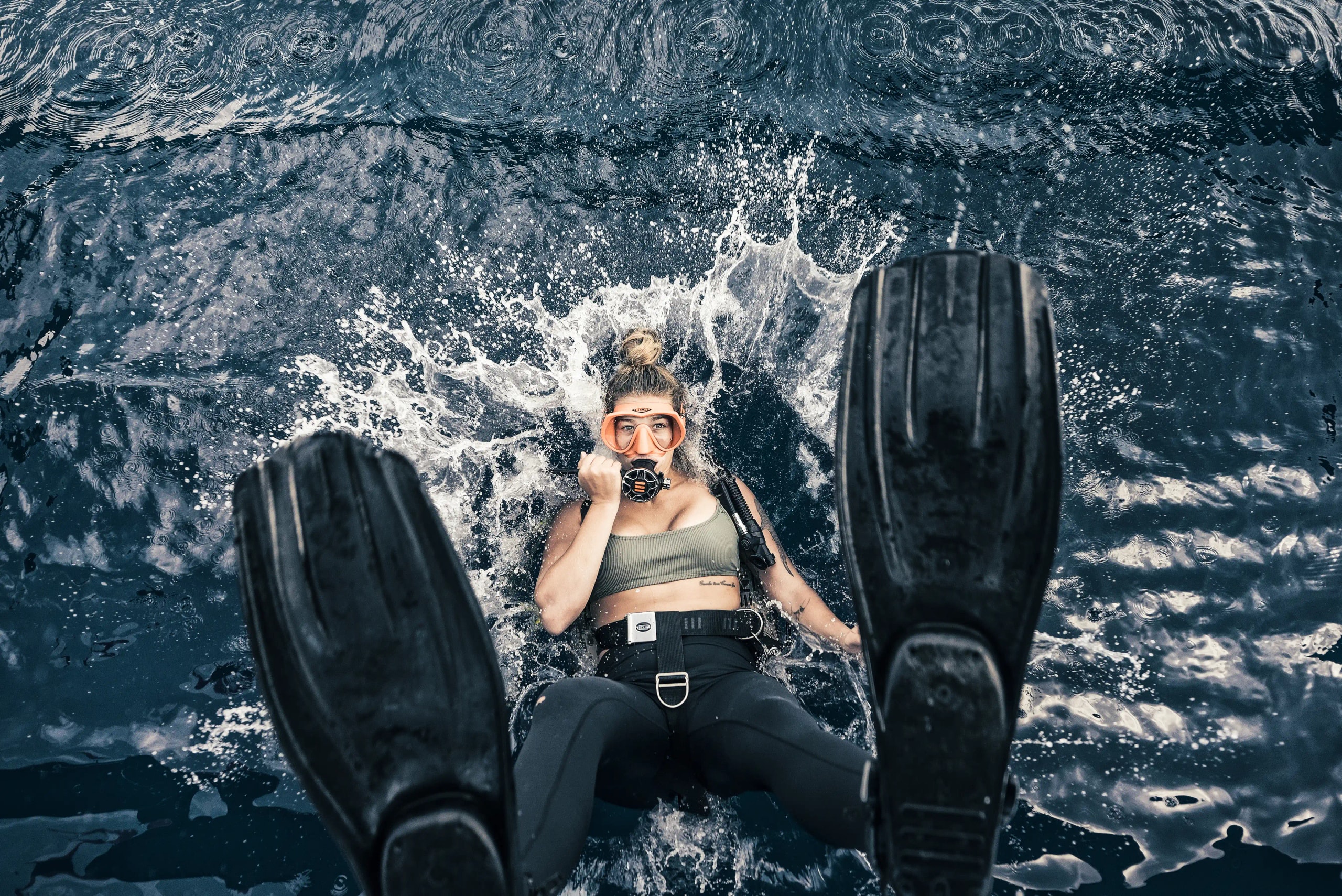 Image 17: Scuba diver splashing into the water backward, seen from above