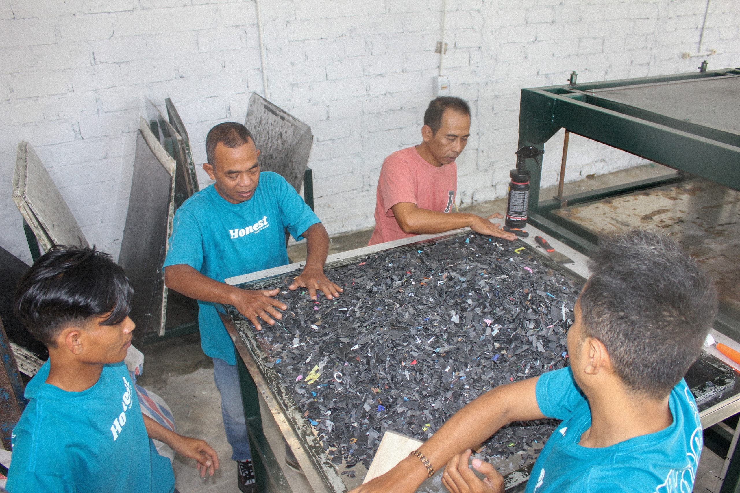 he team processing shredded plastic waste into recycled materials in Lombok.